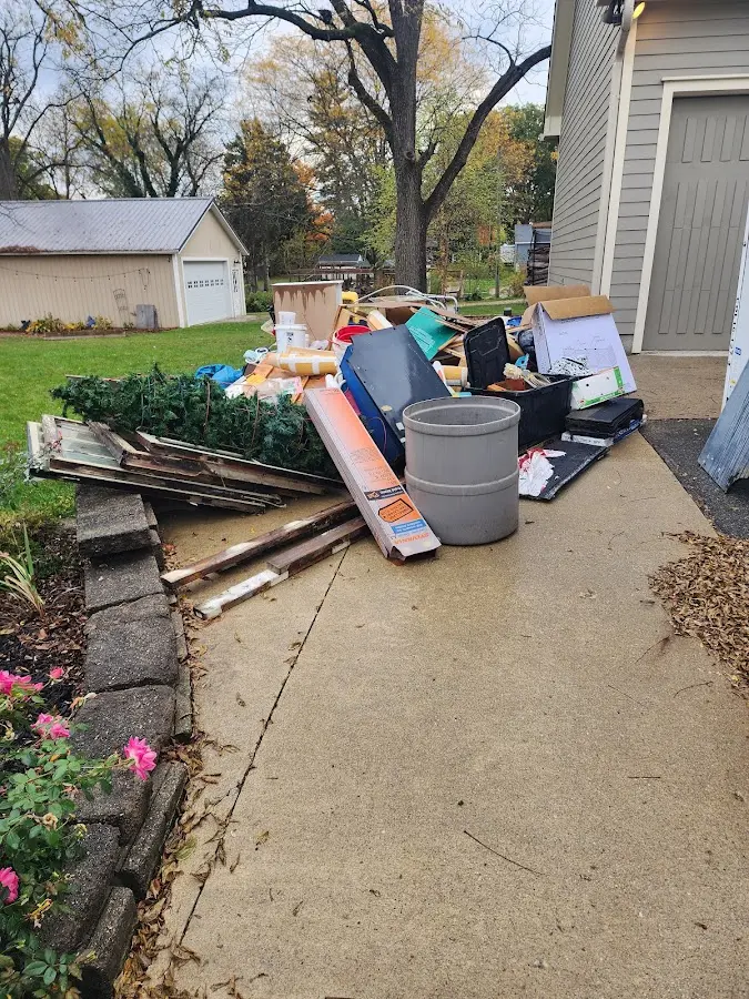 Dumpster being loaded with debris for 12 Yard Dumpster Rental in Ammon